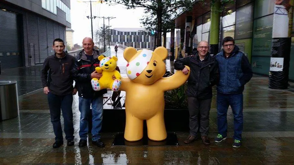 The Austins Ices team with Pudsey Bear at a Children in Need event