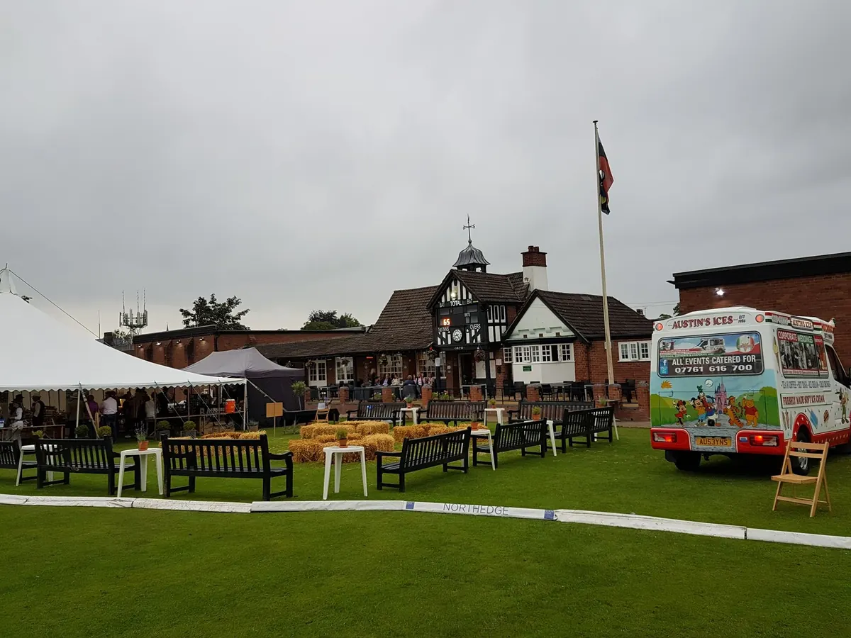 Austins Ices van beside a marquee at a summer garden event
