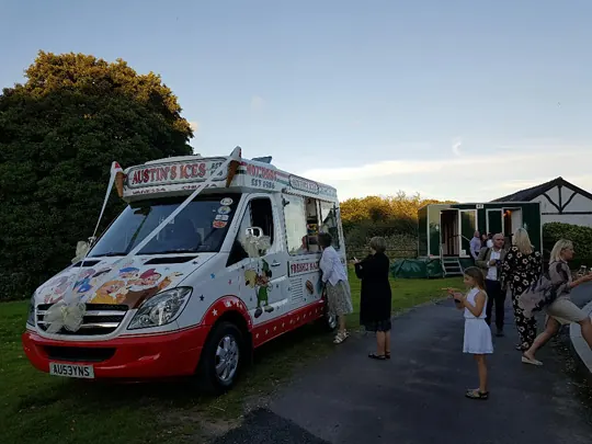 Ribbon-dressed Austins Ices van at a wedding at Holford Hall