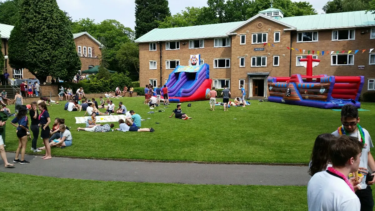 Guests enjoying a summer fun day on the lawn with the Austins Ices van