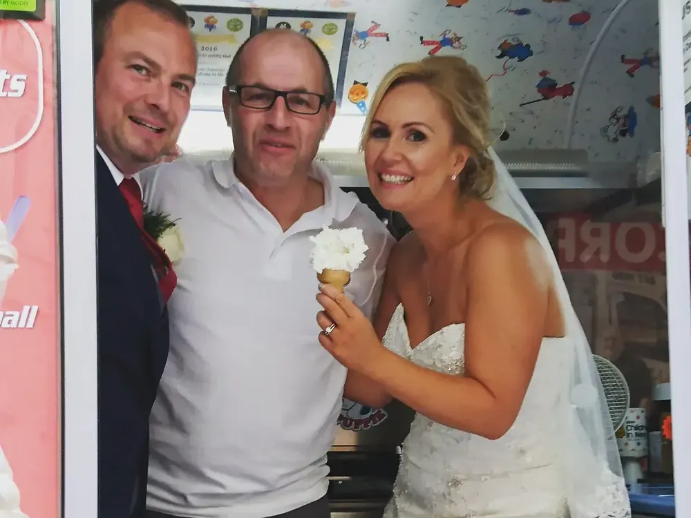 Austin with a newly married couple inside the ice cream van on their wedding day