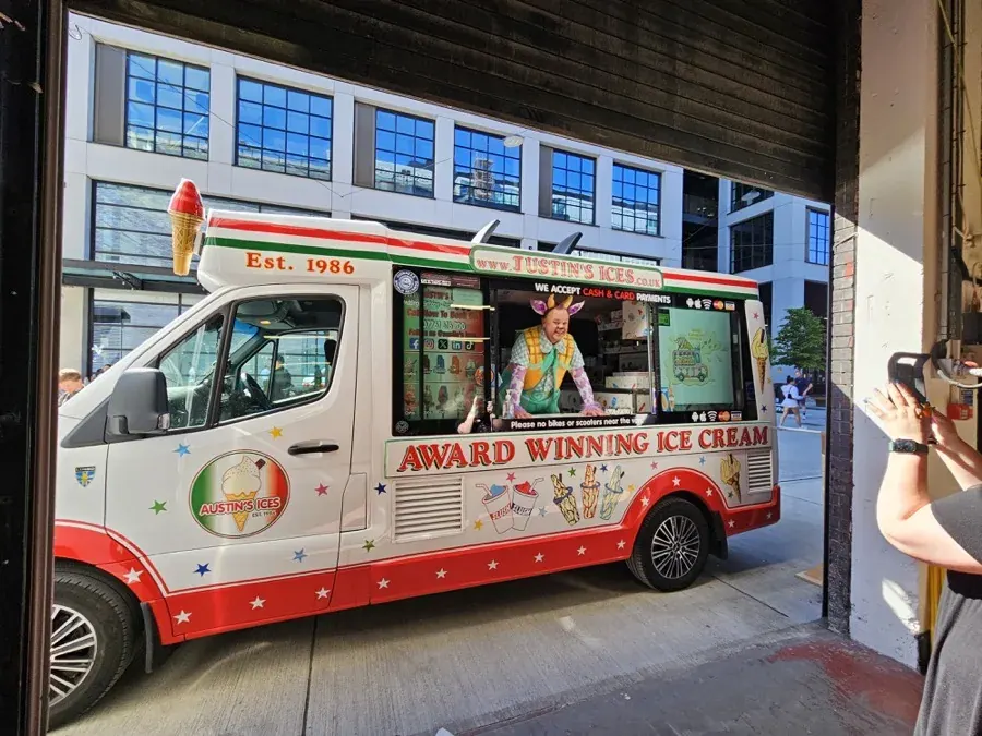 Austins Ices van serving from the hatch outside a Manchester office