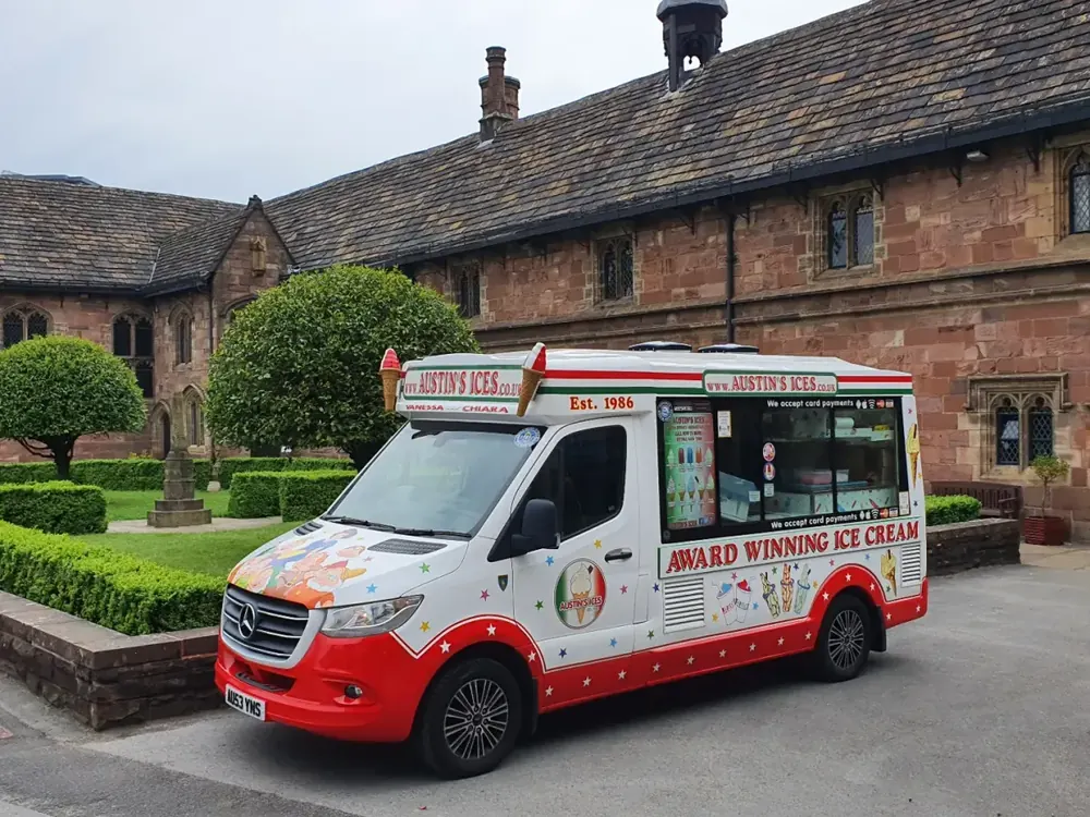Austins Ices ice cream van parked outside a historic hall for a wedding