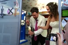 A newlywed bride and groom being served soft-serve ice cream by Austins Ices